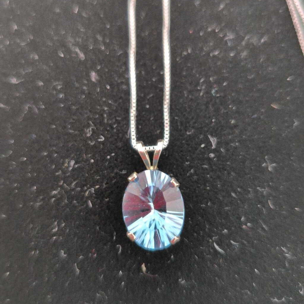 Oval Cut Blue Topaz set in 14K White Gold on an 18" 14K White Gold Chain.