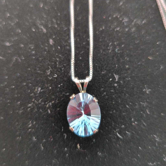 Oval Cut Blue Topaz set in 14K White Gold on an 18" 14K White Gold Chain.